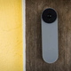 A photo of the Nest Doorbell camera on a plank of wood